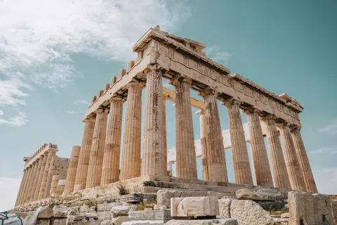 The Parthenon's full colonnaded facade rising against the sky atop the Acropolis
