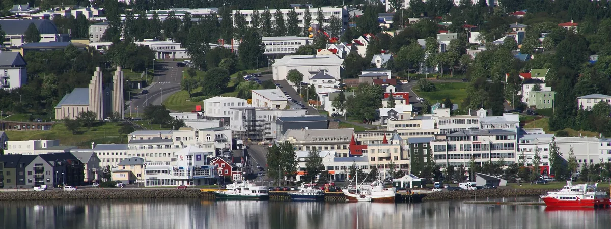 Colorful downtown Akureyri along Eyjafjörður fjord with Akureyrarkirkja church on the hill above