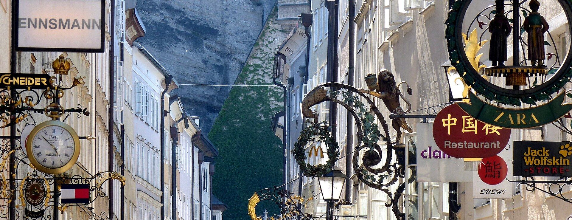Getreidegasse's ornate wrought-iron guild signs hanging above the pedestrian street in Salzburg's old town