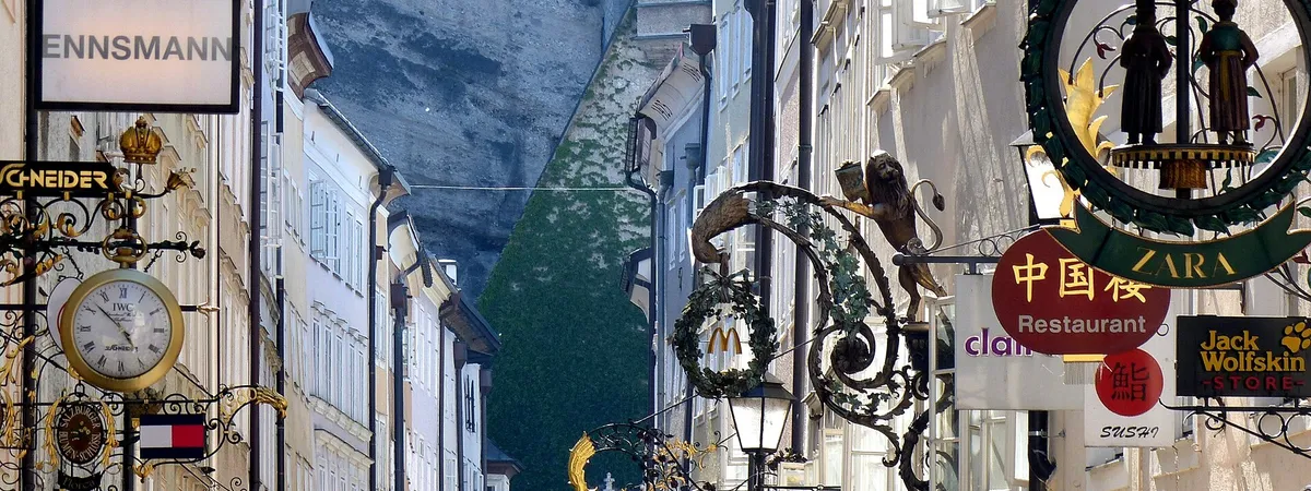 Getreidegasse's ornate wrought-iron guild signs hanging above the pedestrian street in Salzburg's old town