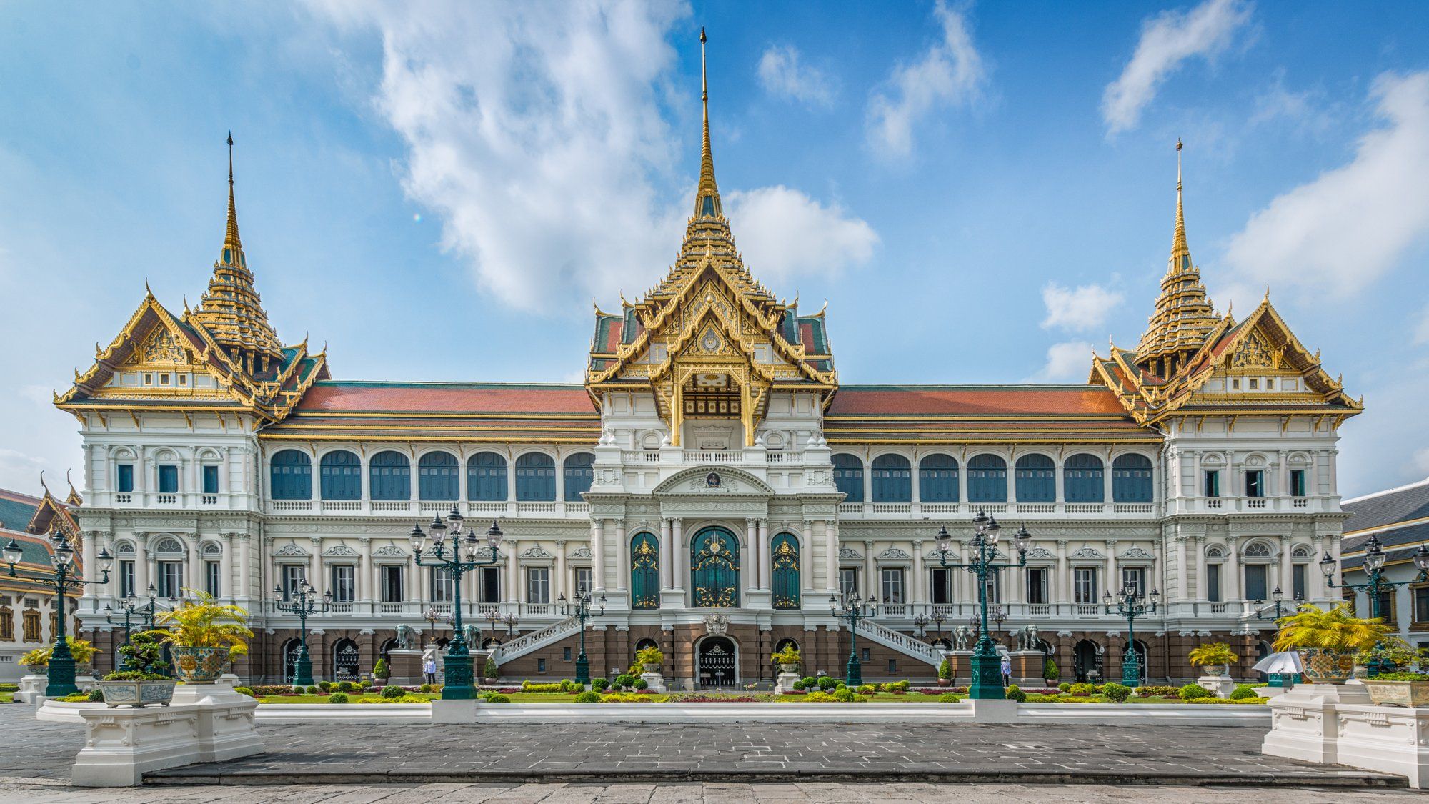 The Grand Palace's golden spires and colorful mosaic-tiled buildings in Bangkok