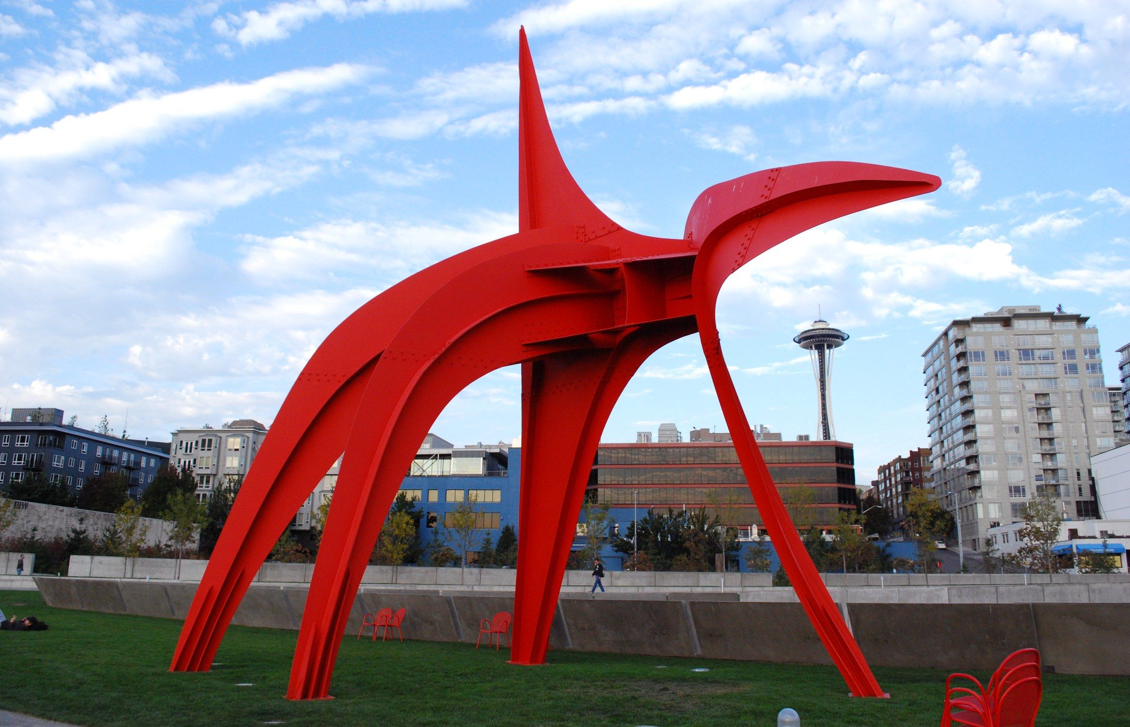 Alexander Calder's giant red steel "Eagle" sculpture at Olympic Sculpture Park, with the Space Needle visible in the background