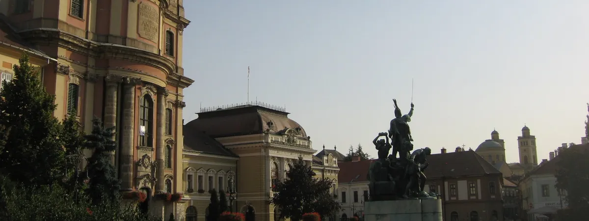 Dobó István tér in Eger's old town, with the Minorite Church, the Town Hall, and the István Dobó memorial statue