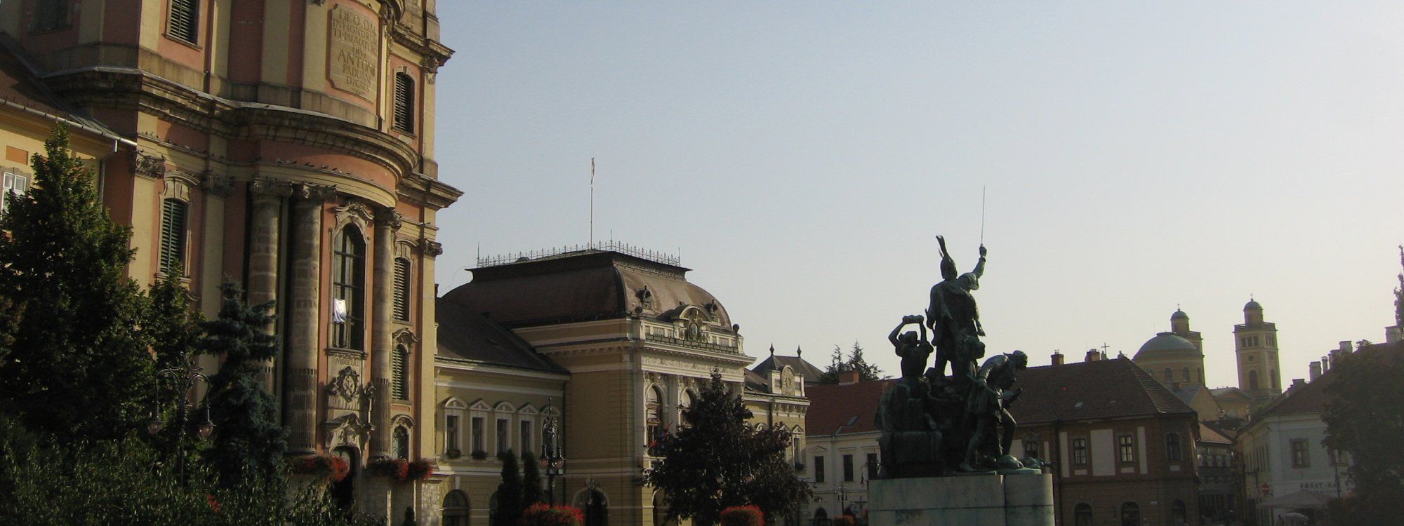 Dobó István tér in Eger's old town, with the Minorite Church, the Town Hall, and the István Dobó memorial statue