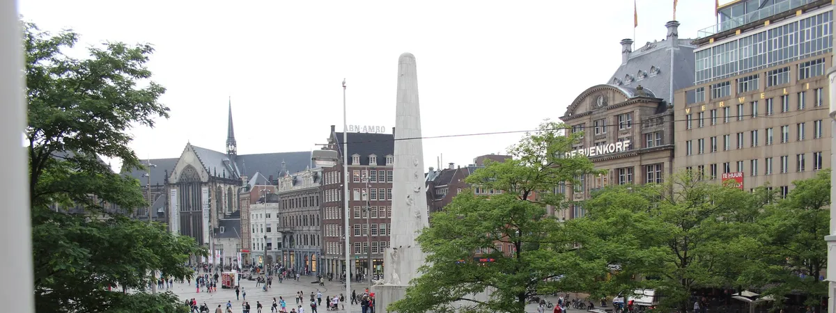 Dam Square in Amsterdam with the Royal Palace, Nieuwe Kerk, and the National Monument obelisk