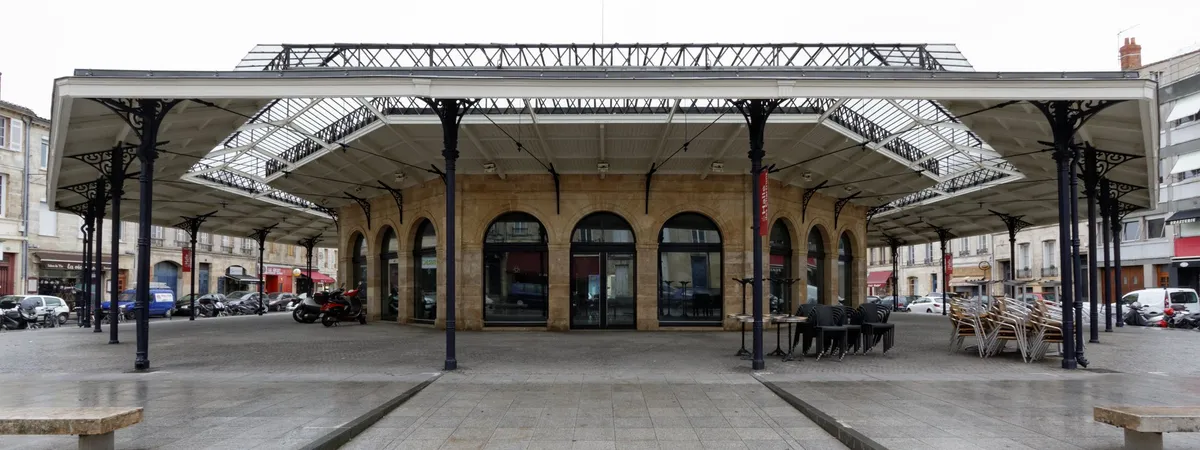 The Halle des Chartrons, a 19th-century covered market hall with an iron-and-glass roof, on a plaza in the Chartrons district of Bordeaux