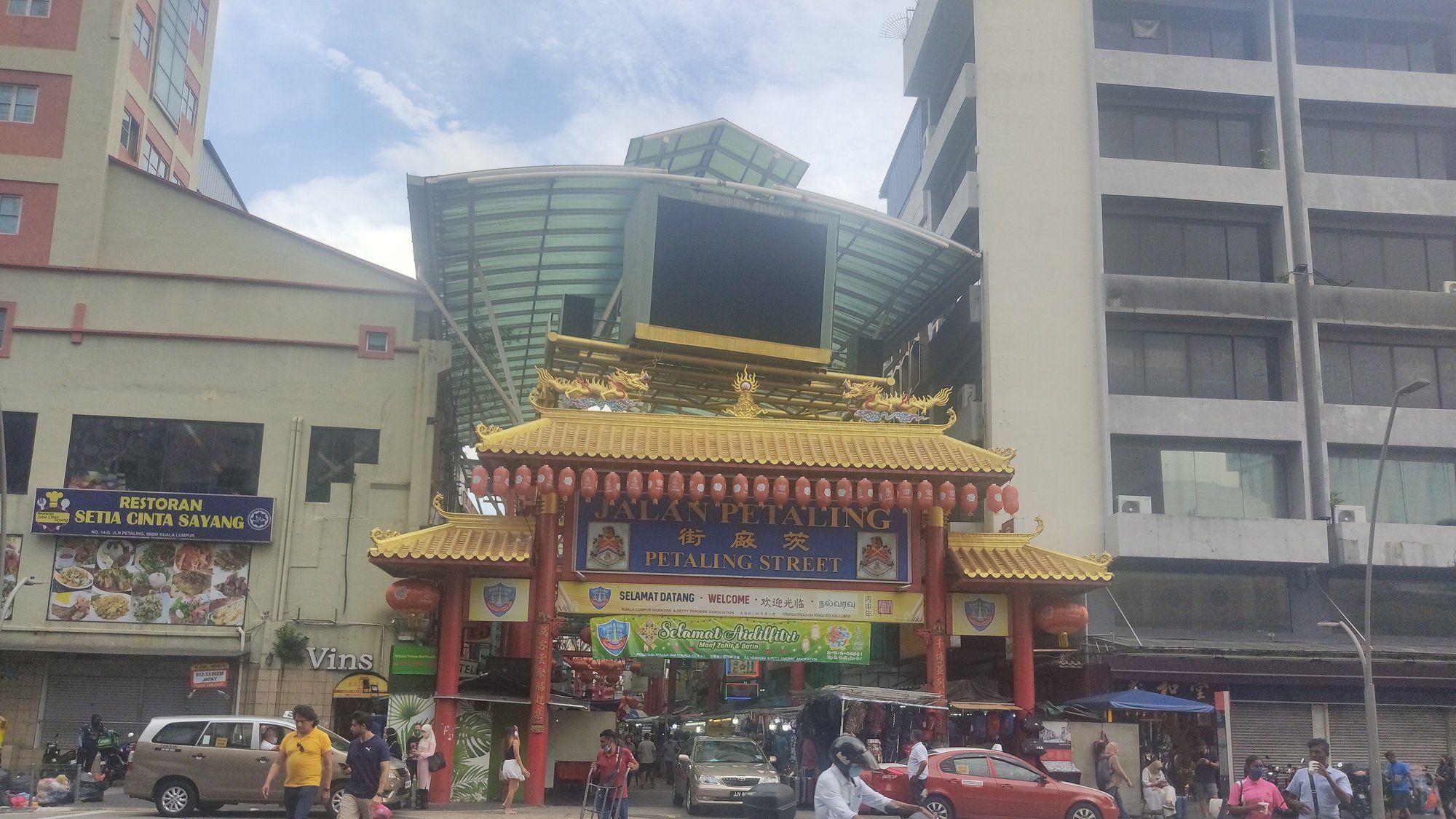 The golden, dragon-topped arch marking the Petaling Street entrance to Kuala Lumpur's Chinatown