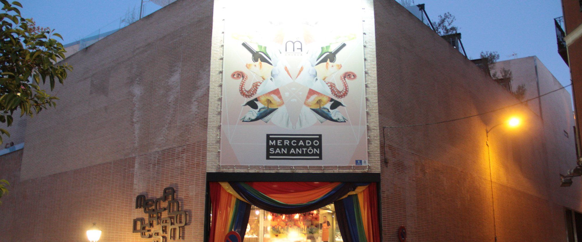 The entrance to Mercado de San Antón in Chueca, decorated with rainbow banners during Madrid Pride