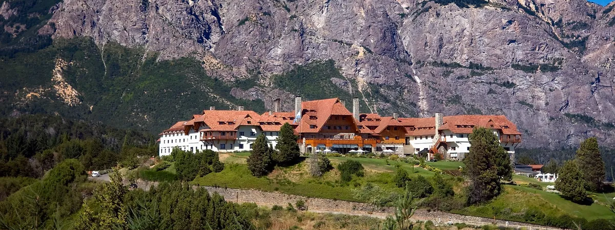 Hotel Llao Llao's alpine-style building on a hilltop between Lago Nahuel Huapi and the Andes, seen from across the valley