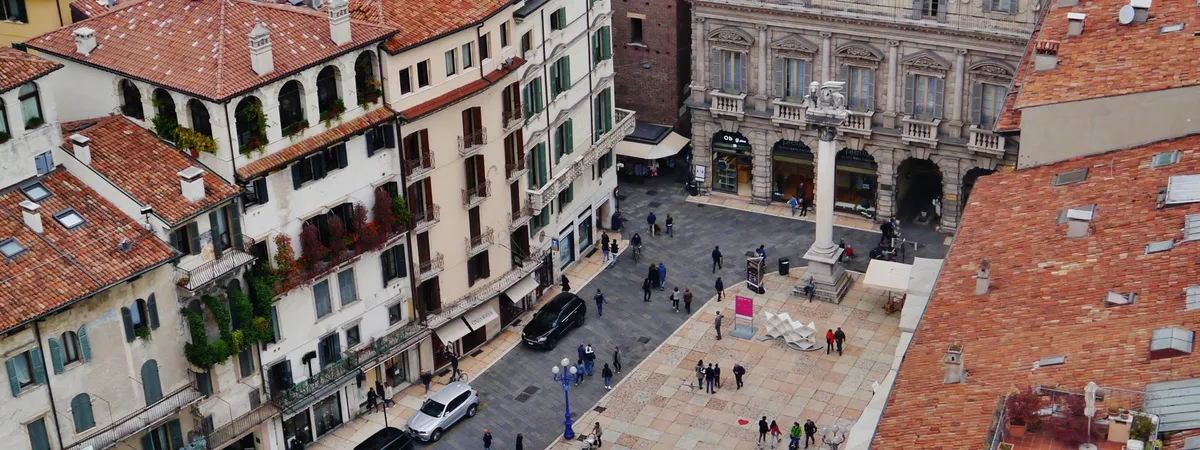Piazza delle Erbe seen from the Torre dei Lamberti, with its frescoed houses and the Venetian lion column