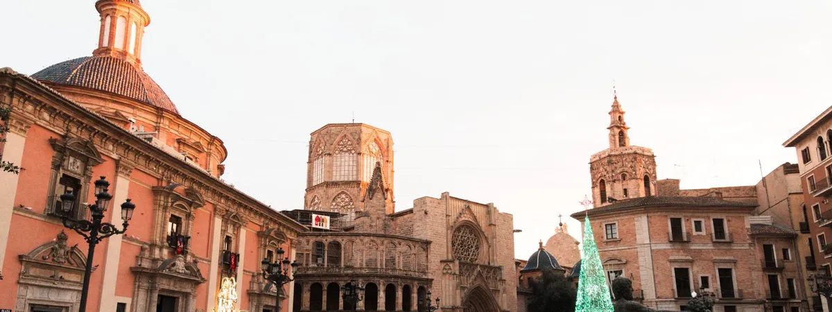 Valencia Cathedral and the Miguelete bell tower seen from Plaza de la Virgen, with the Turia fountain in the foreground