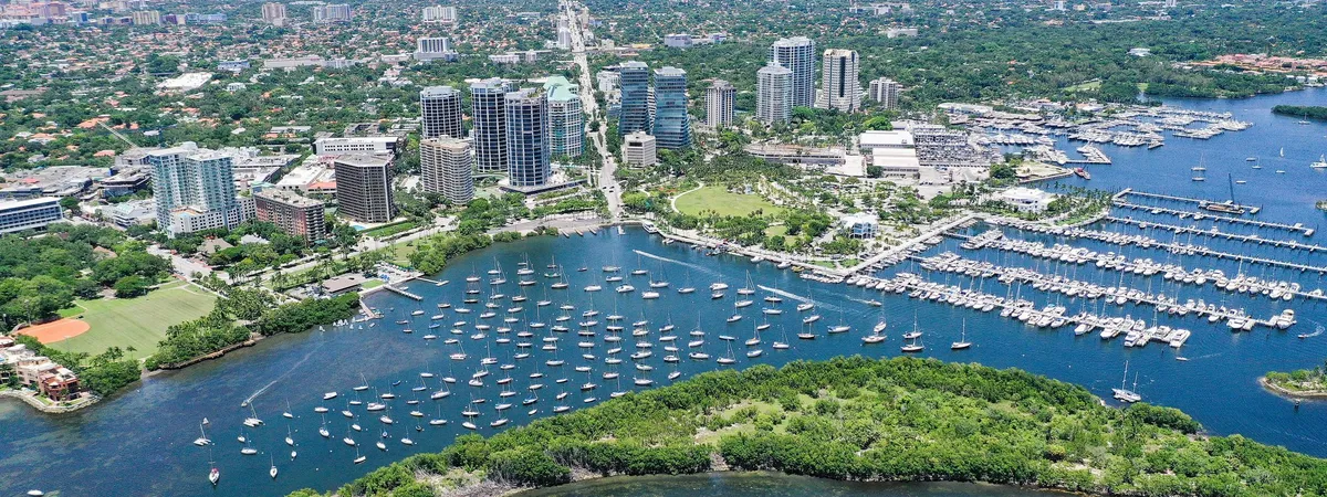 Aerial view of Coconut Grove, with sailboats moored off Dinner Key, its low-rise village center, and the marina reaching out into Biscayne Bay