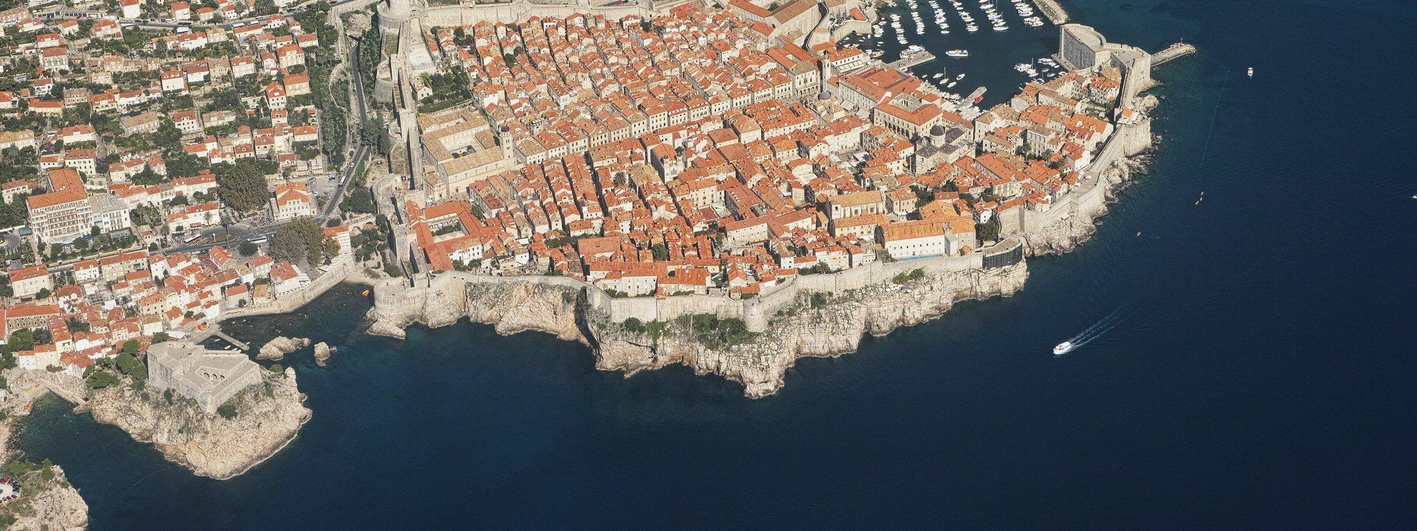 Aerial view of Dubrovnik's walled Old Town jutting into the Adriatic, red rooftops packed inside the stone ramparts
