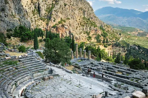 Delphi's ancient theatre and the Temple of Apollo's columns set into the slope of Mount Parnassus