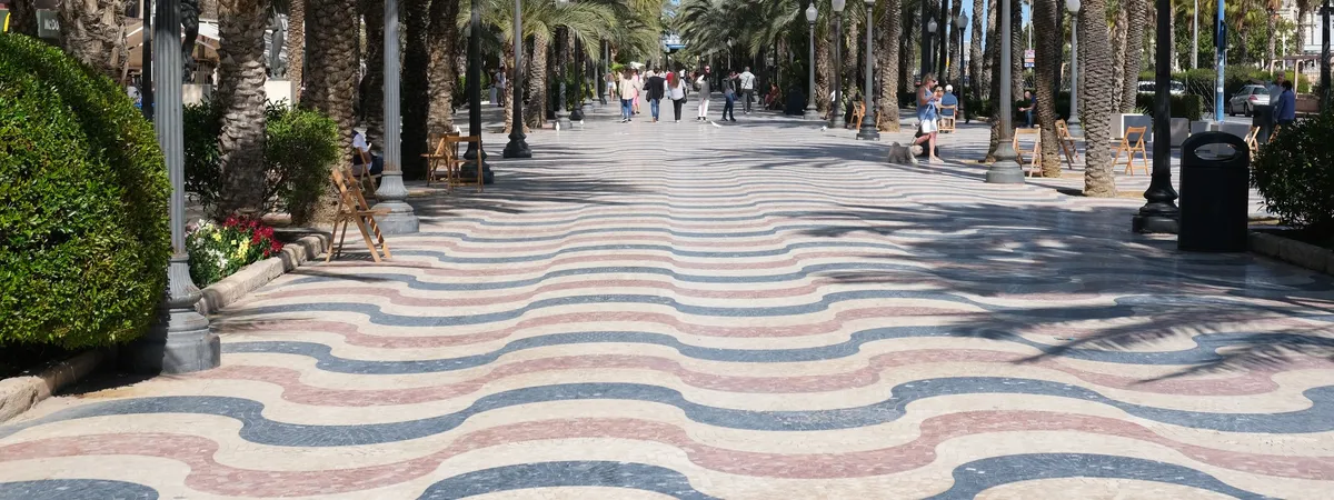 The wave-patterned mosaic paving of the Explanada de España, Alicante's palm-lined seafront promenade