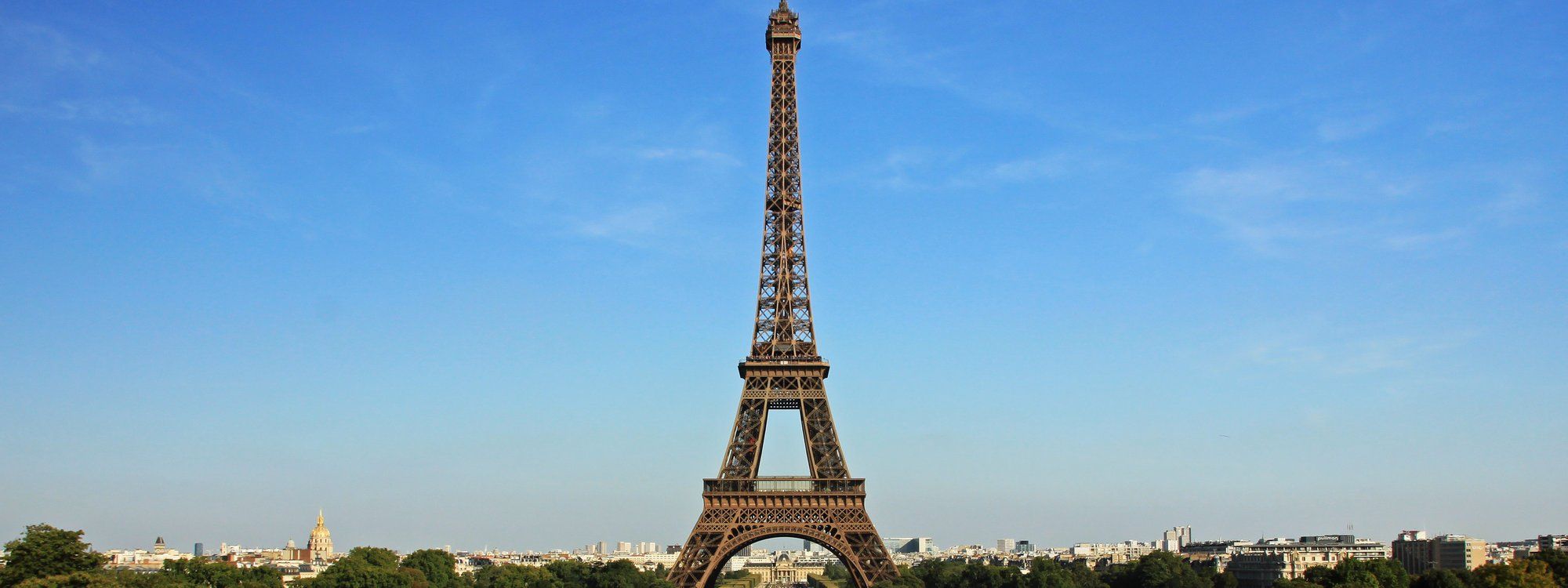 The Eiffel Tower rising above the Paris skyline, seen from the Trocadéro gardens