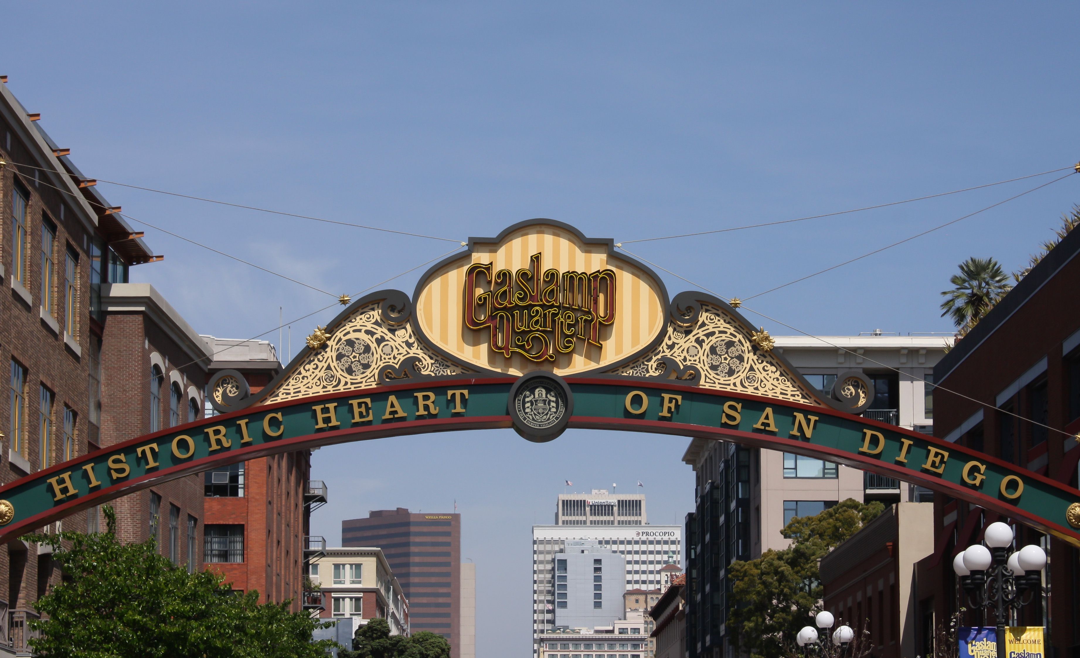 The illuminated "Gaslamp Quarter — Historic Heart of San Diego" arch sign spanning 5th Avenue, with downtown high-rises behind it
