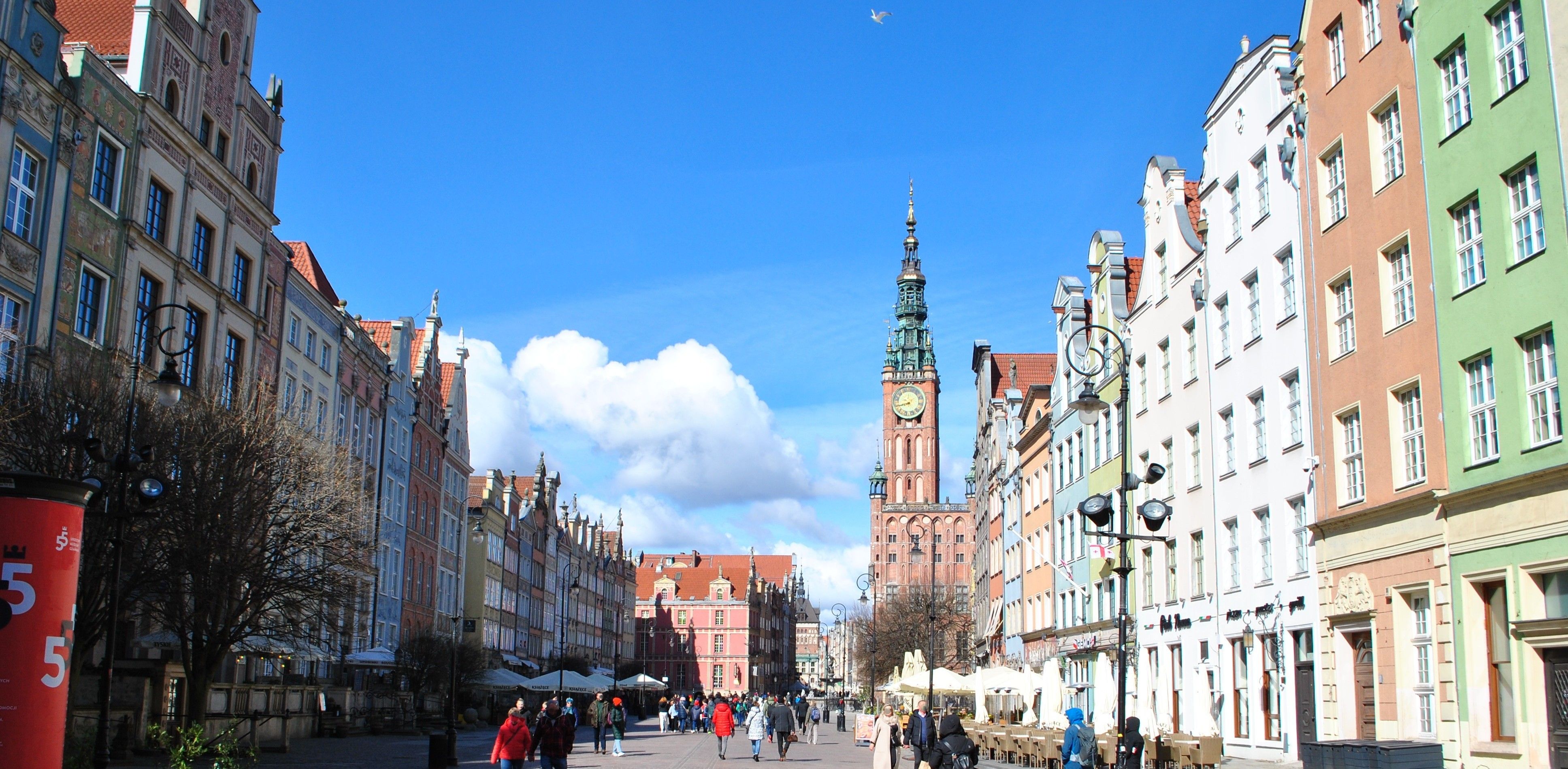 Długa Street in Gdańsk's Main Town, lined with colorful merchant houses and leading to the Main Town Hall's clock tower