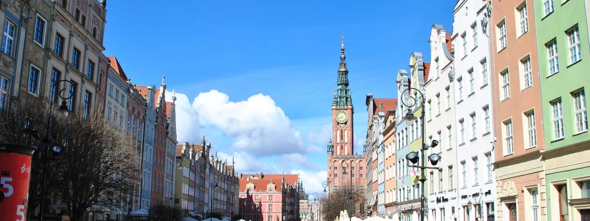 Długa Street in Gdańsk's Main Town, lined with colorful merchant houses and leading to the Main Town Hall's clock tower