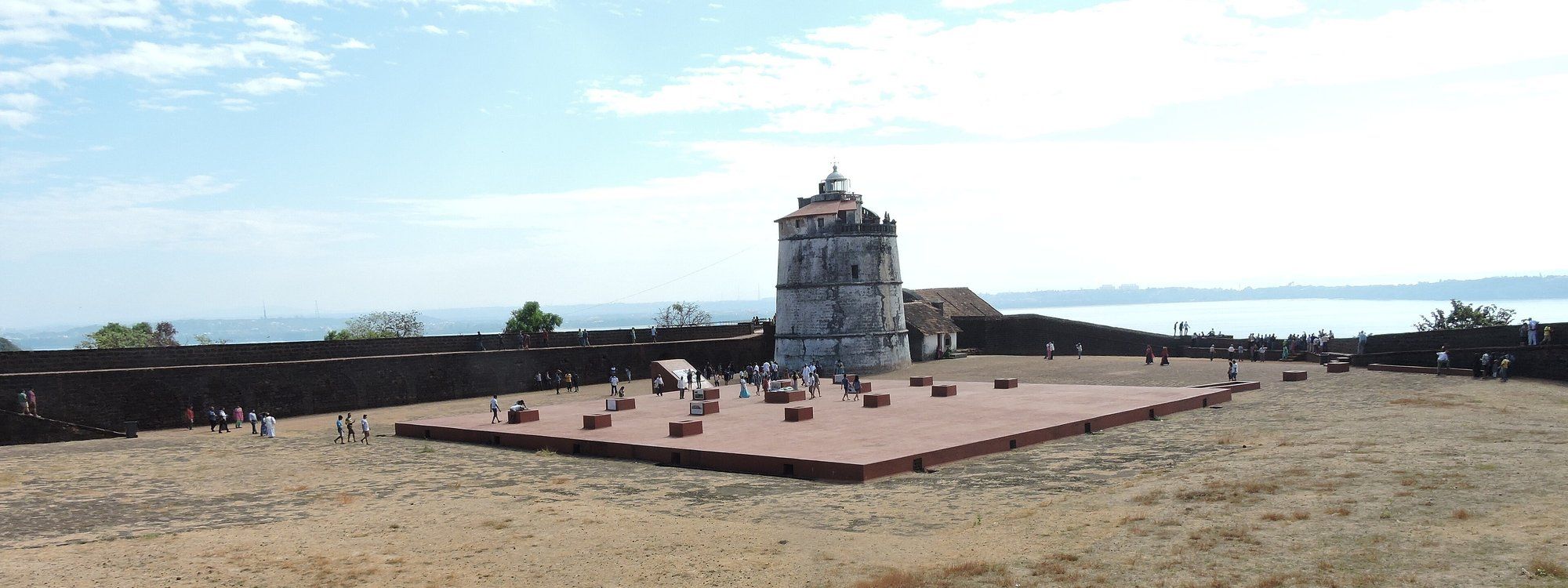 The whitewashed lighthouse tower inside Fort Aguada's ramparts, overlooking the Arabian Sea