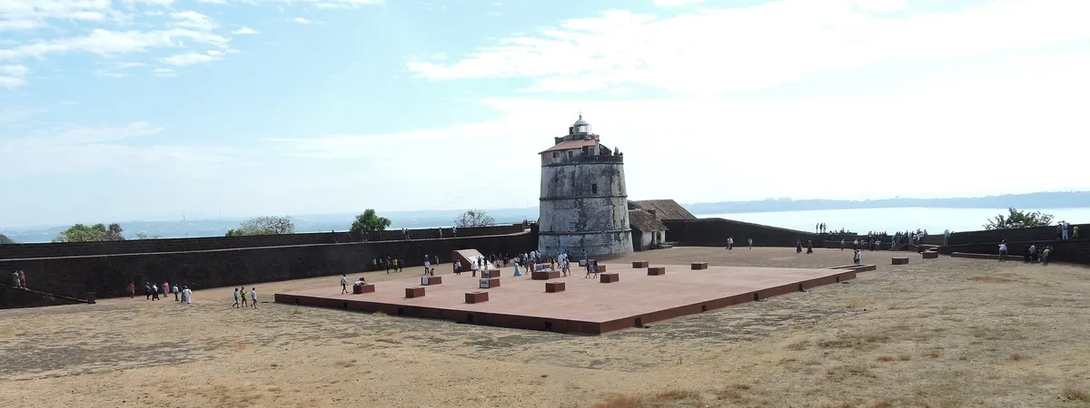 The whitewashed lighthouse tower inside Fort Aguada's ramparts, overlooking the Arabian Sea
