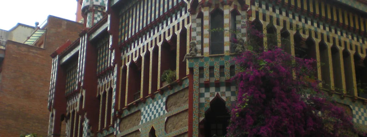 The colorful ceramic-tiled facade of Casa Vicens, Antoni Gaudí's first major building, on a narrow street in Gràcia
