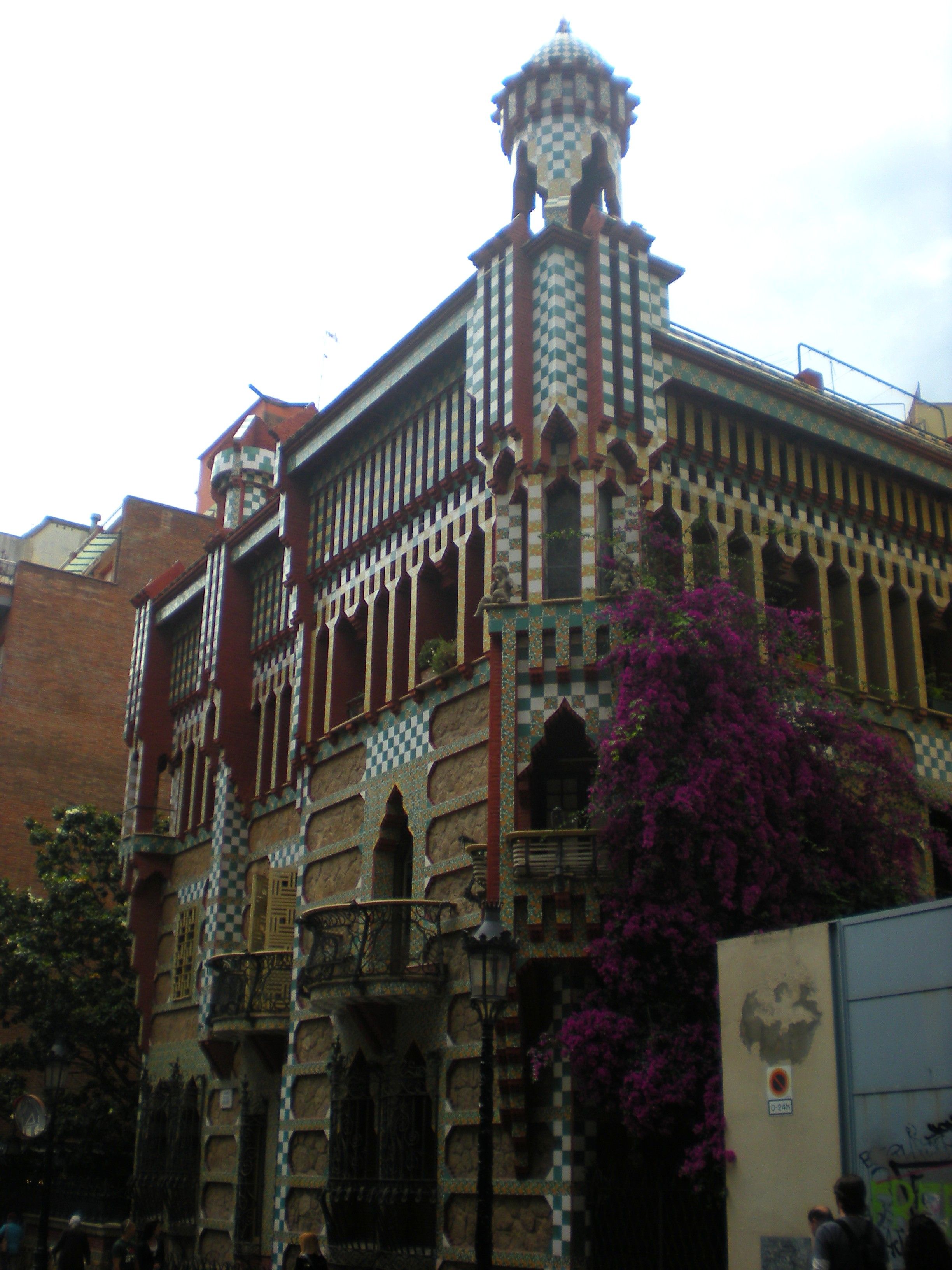 The colorful ceramic-tiled facade of Casa Vicens, Antoni Gaudí's first major building, on a narrow street in Gràcia