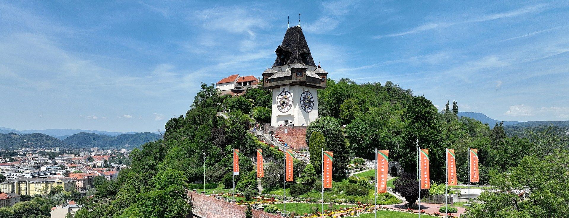 The Uhrturm clock tower atop Graz's Schlossberg hill, overlooking the old town's red rooftops
