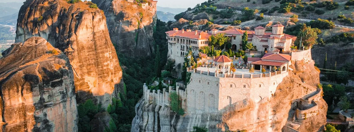 Meteora's monasteries crowning the sandstone pillars at golden hour