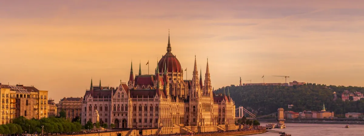 The Hungarian Parliament Building glowing at sunset along the Danube