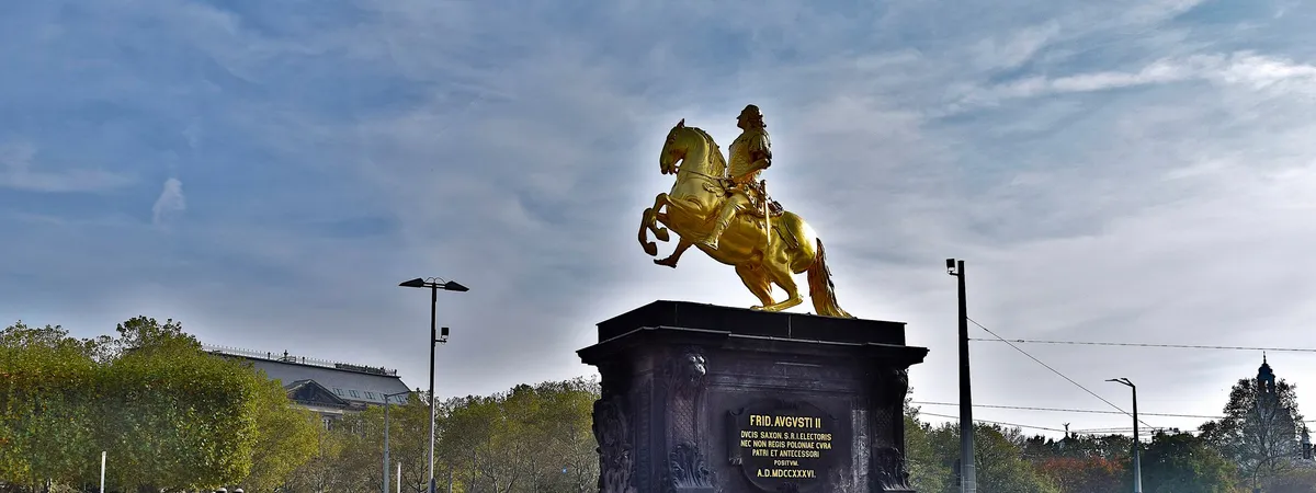 The gilded Goldener Reiter equestrian statue of Augustus the Strong on Hauptstraße in Dresden's Innere Neustadt, seen against a blue sky
