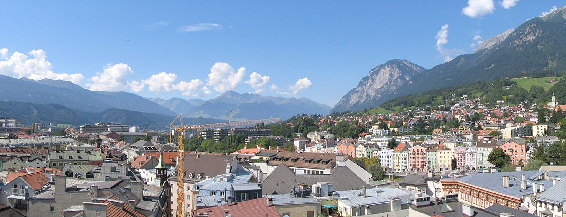 Innsbruck's old town rooftops with the snow-capped Nordkette mountains rising directly behind the city