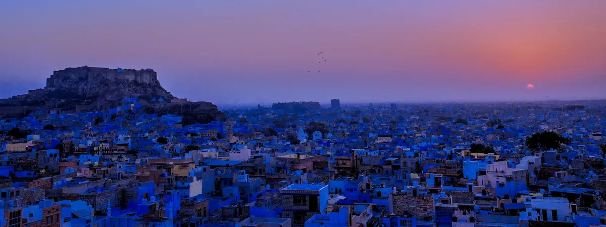 Mehrangarh Fort rising over Jodhpur's blue-painted old city at sunset