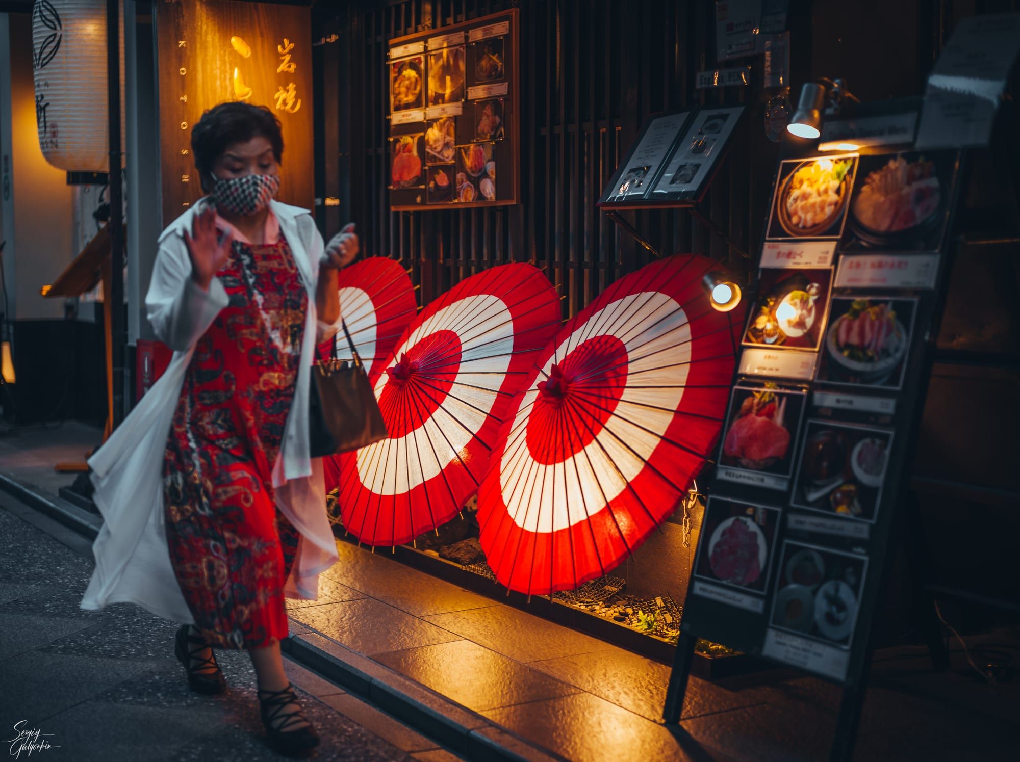 Pontocho Alley in Kyoto lit up by lanterns and restaurant signs at night
