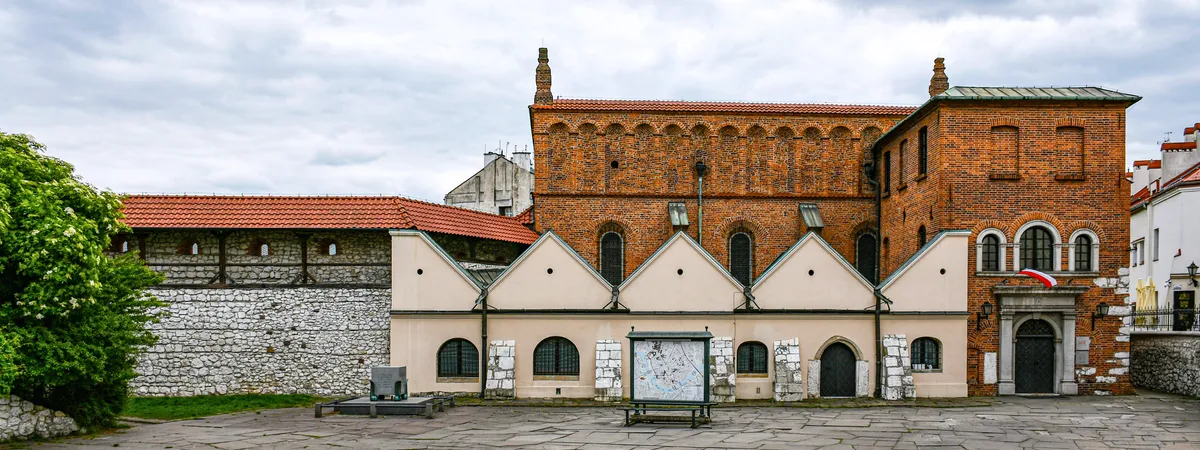The Old Synagogue's brick facade and stepped gables on Szeroka Street in Kazimierz, Kraków
