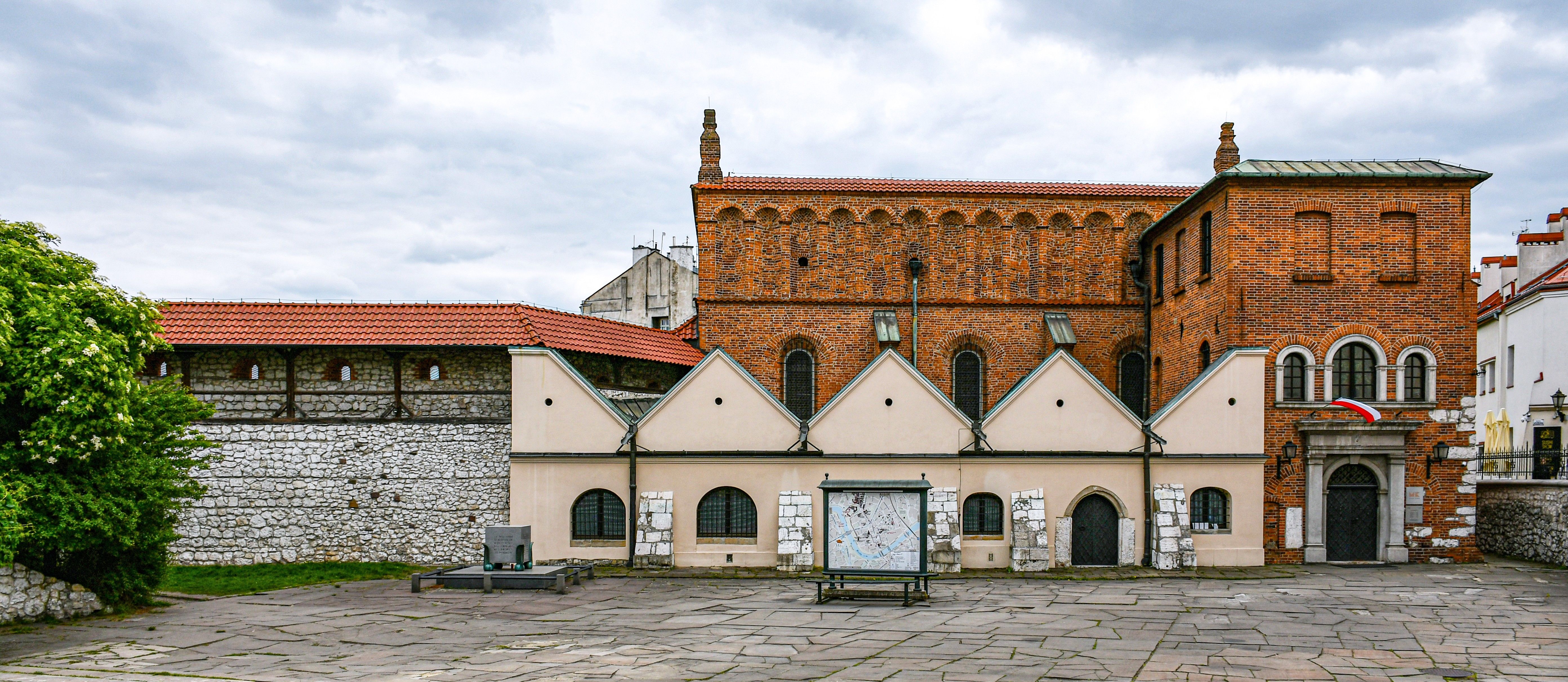 The Old Synagogue's brick facade and stepped gables on Szeroka Street in Kazimierz, Kraków
