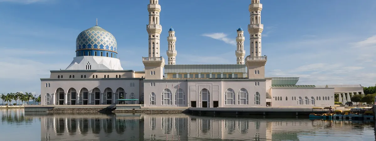 The Kota Kinabalu City Mosque, known as the Floating Mosque, reflected in its lagoon on Likas Bay