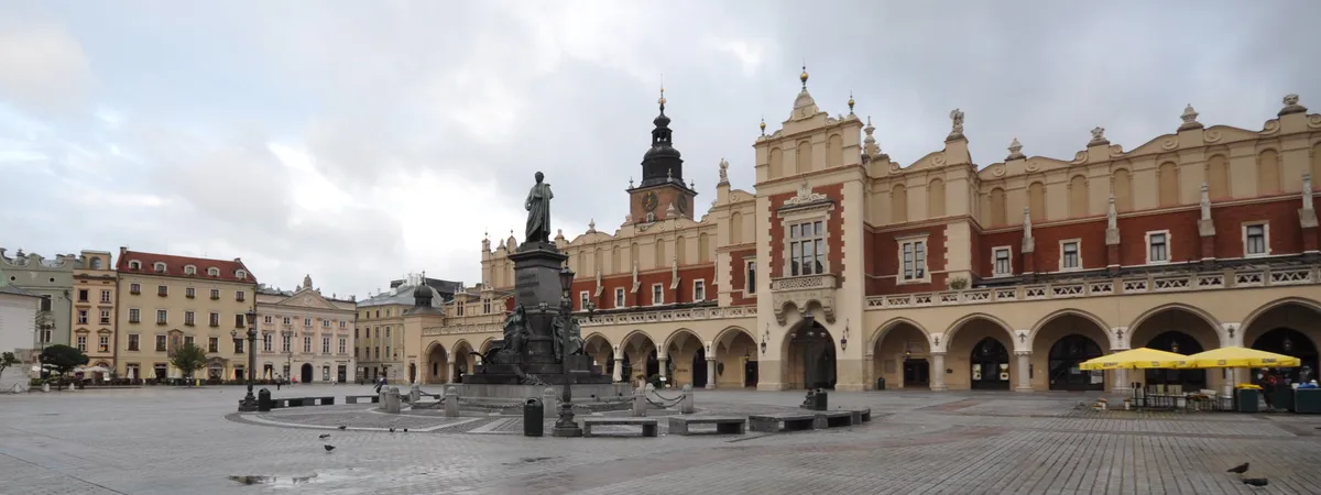 The Cloth Hall and Town Hall Tower on Kraków's Main Market Square, with the Adam Mickiewicz Monument in front
