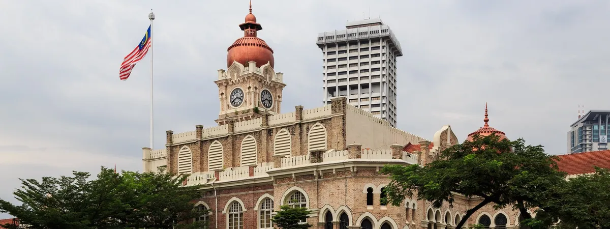 The copper dome and clock tower of the Sultan Abdul Samad Building at Merdeka Square in Kuala Lumpur