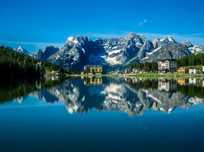 Lago di Misurina on a still morning, mirroring the Sorapis group and the hotels along its shore