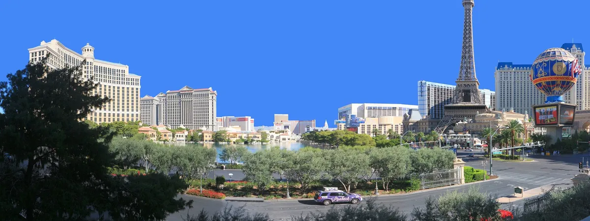 View of the Las Vegas Strip from across the Bellagio fountains, with Bellagio, Caesars Palace, and the Eiffel Tower at Paris Las Vegas visible along the boulevard