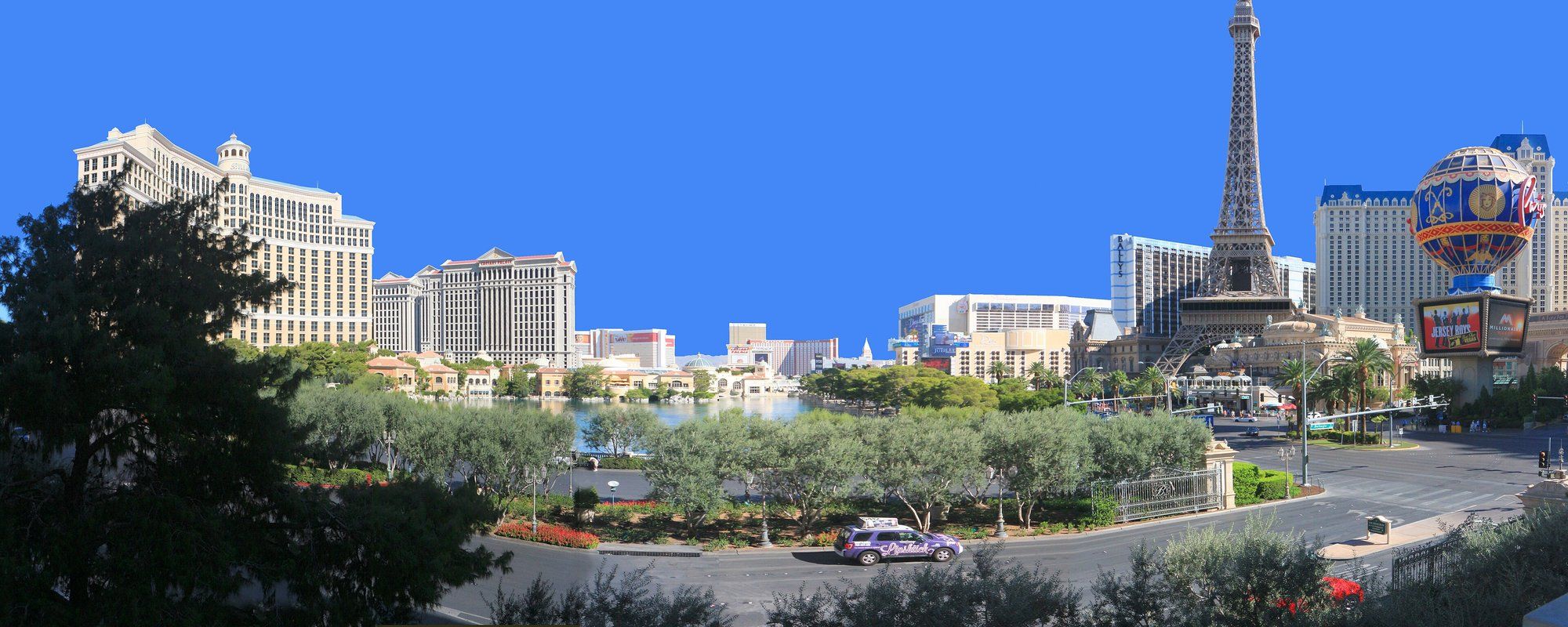 View of the Las Vegas Strip from across the Bellagio fountains, with Bellagio, Caesars Palace, and the Eiffel Tower at Paris Las Vegas visible along the boulevard