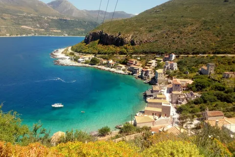 Limeni's stone tower-houses lining a turquoise Mani bay