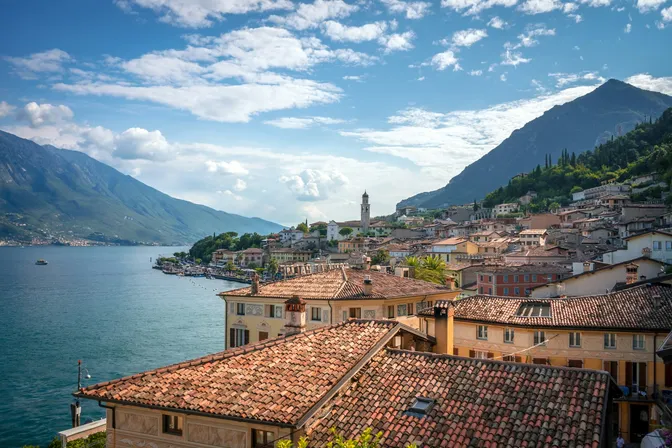 The tiled roofs of Limone sul Garda pressed between Lake Garda and the rock wall behind the town