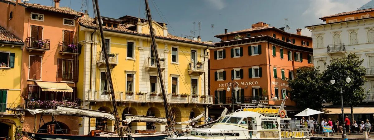 Coloured houses and moored boats around Malcesine’s old harbour on Lake Garda