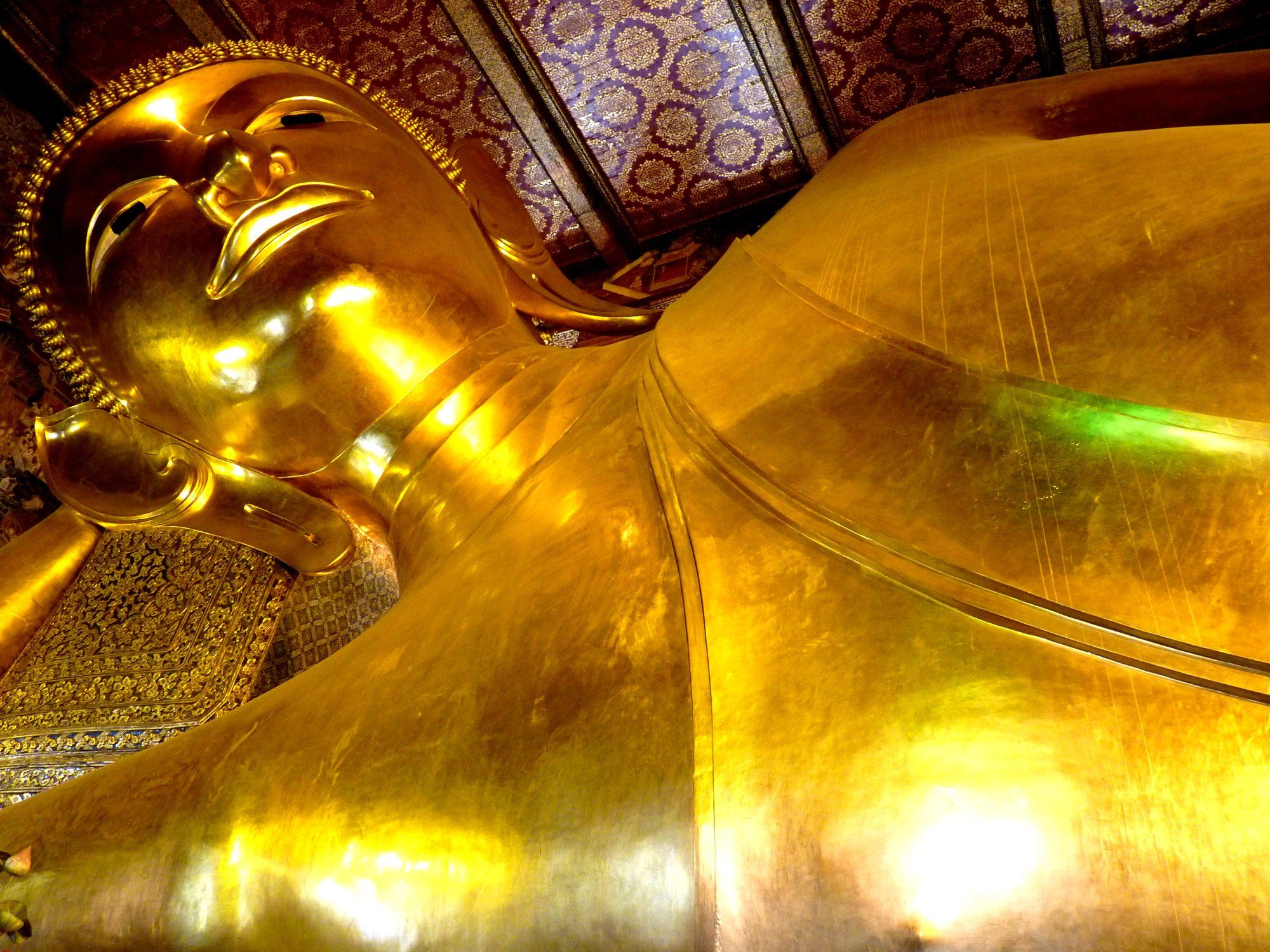 The 46-metre gold-covered Reclining Buddha statue inside Wat Pho temple in Bangkok's Old City