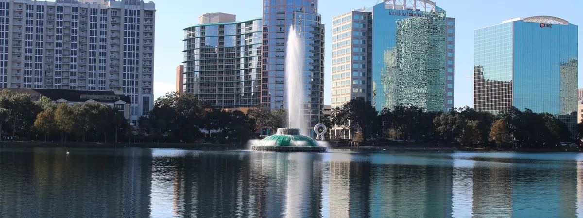 The Linton E. Allen Memorial Fountain spraying water on Lake Eola in front of the downtown Orlando skyline