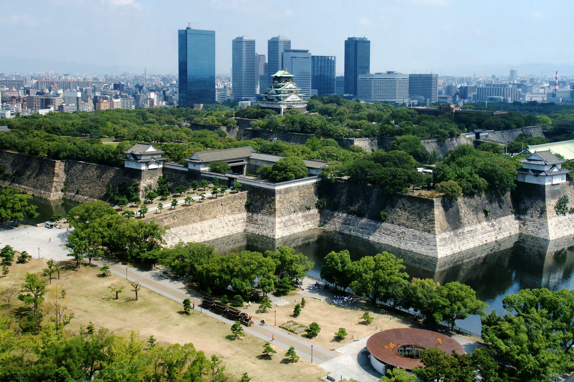 Osaka Castle's main tower rising above its stone walls and moat