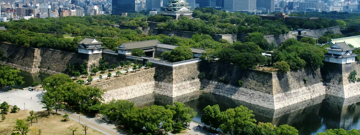 Osaka Castle's main tower rising above its stone walls and moat