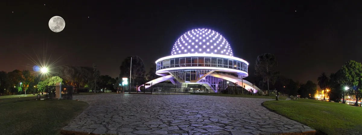 The illuminated dome of the Galileo Galilei Planetarium at night, in Palermo's Parque Tres de Febrero